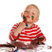 Boy playfully painting on his own face