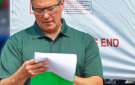 Business owner wearing construction eye protection filling out business forms.