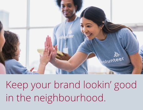 Volunteers wearing branded T-shirts high-fiving with kids. Keep your brand lookin’ good in the neighbourhood.